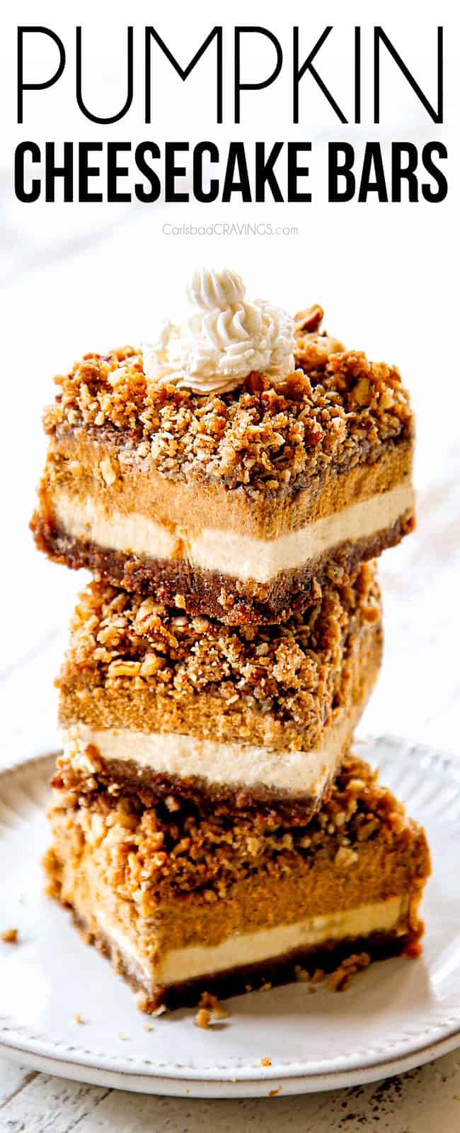 a stack of pumpkin cheesecake bars with streusel topping