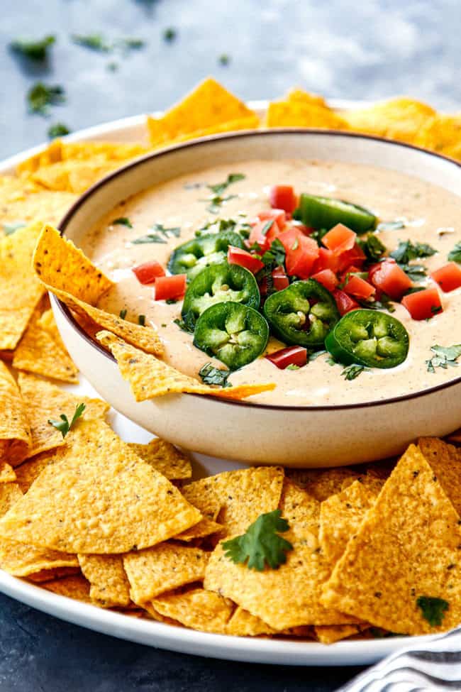 side view of a bowl of white queso dip
