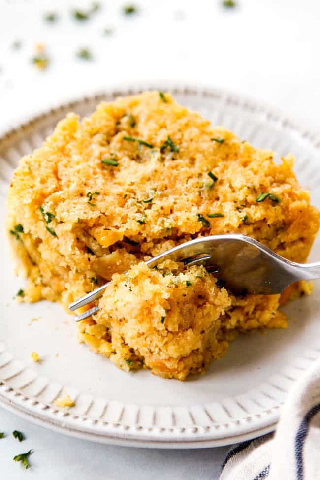 a fork taking a bite out of baked corn casserole recipe