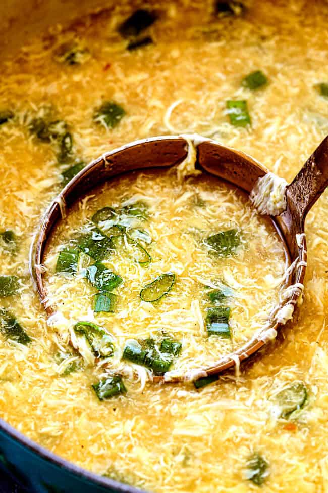 up close of showing how to make Egg Drop Soup by stirring in green onions