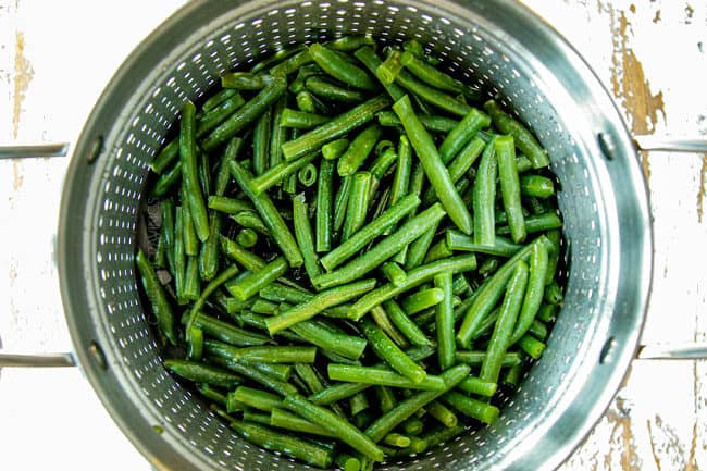 showing how to make green beans by draining green beans after blanching
