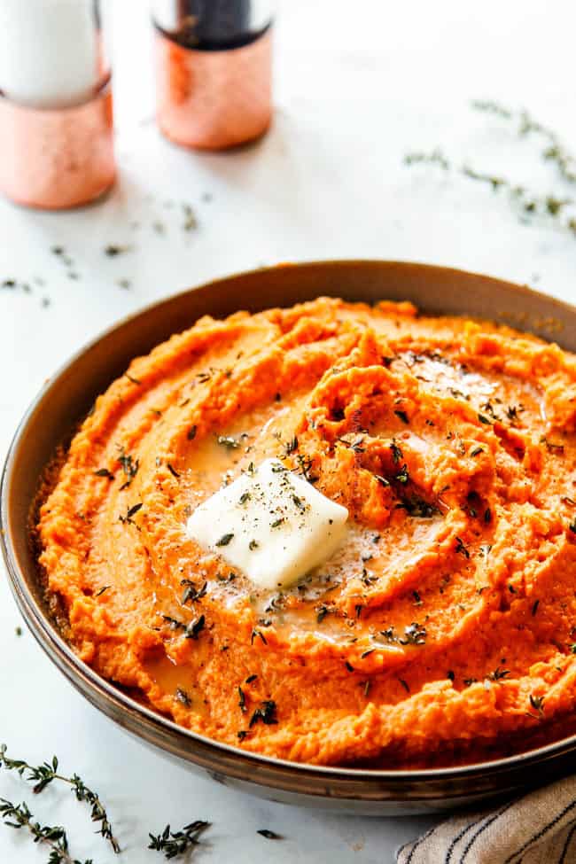 side view of savory mashed sweet potato recipe with milk, butter, cinnamon, sour cream, thyme