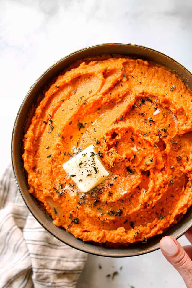 top view of holding a bowl of savory mashed sweet potatoes 
