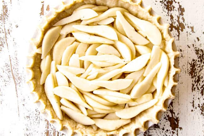 showing how to make Pear Pie by layering pears on pie crust