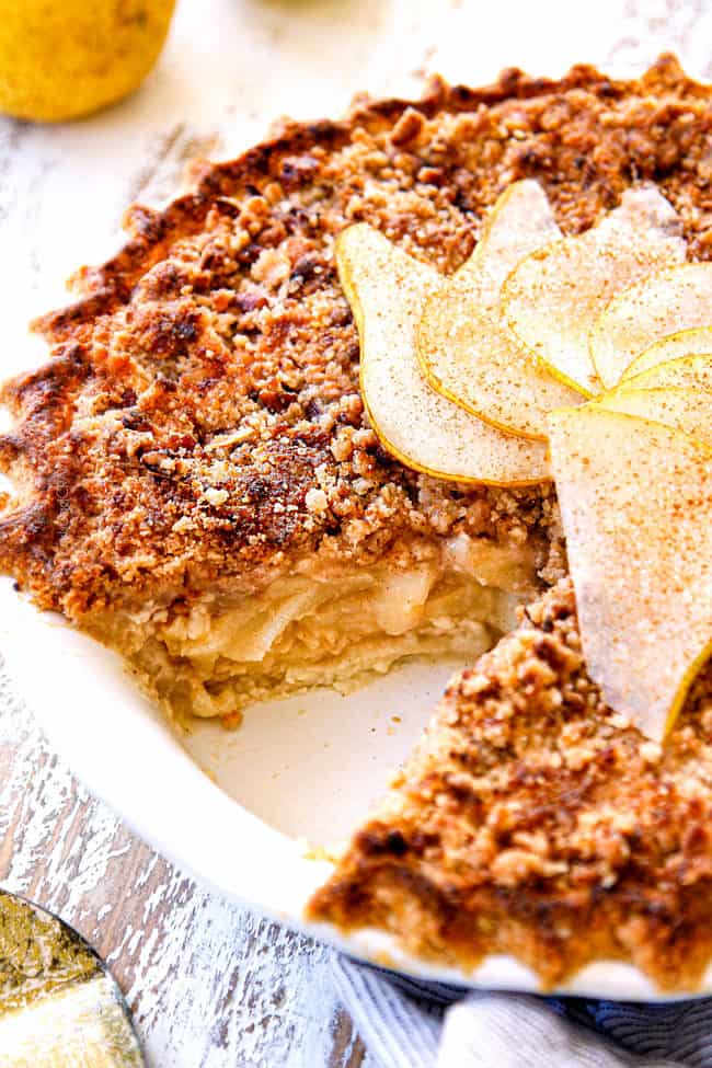 up close of pear pie with streusel topping with a few pieces missing

