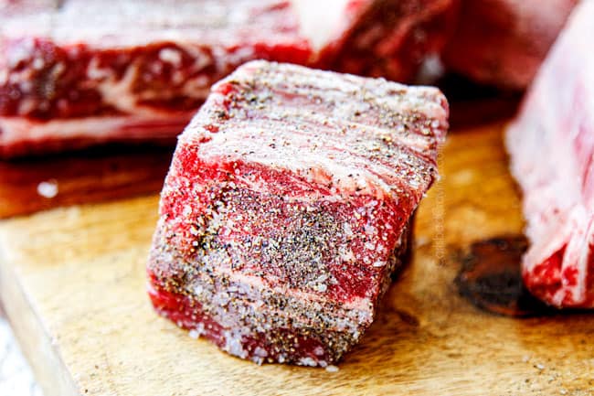 showing how to make short ribs by seasoning with kosher salt and pepper