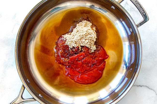 showing how to make cocktail meatball sauce by adding ketchup, sugar, jelly to skillet