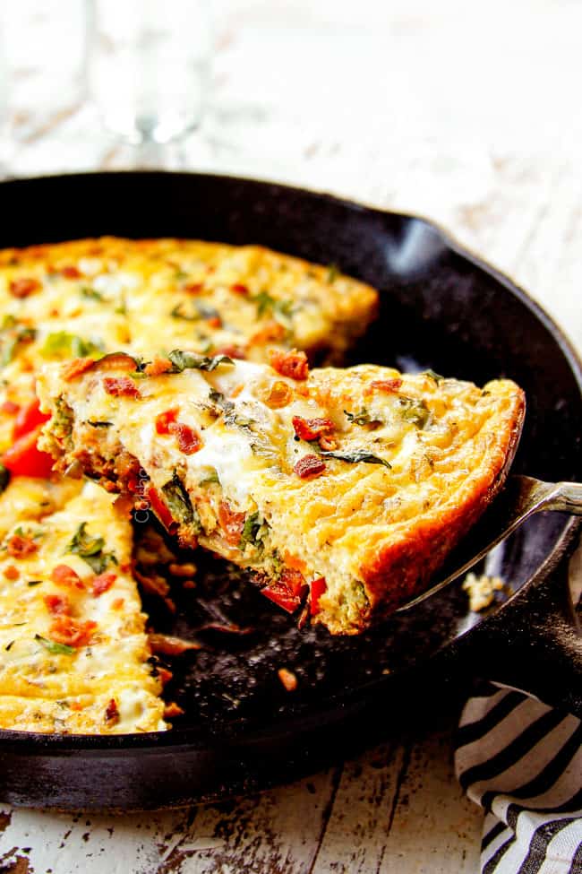 showing how to serve egg frittata recipe by removing a slice from the pan 