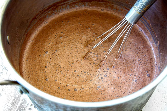 showing how to make homemade hot chocolate recipe by stirring constantly while it comes to a boil
