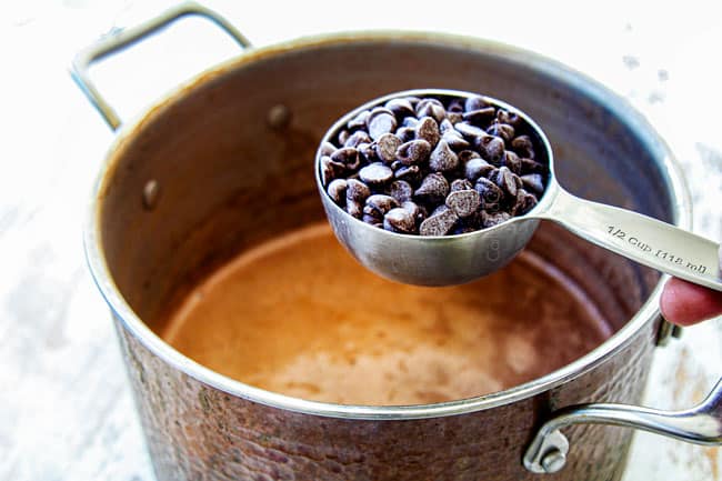 showing how to make best hot chocolate recipe by adding chocolate chips