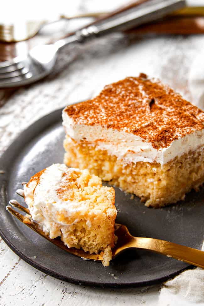 a bite of authentic tres leches cake on a gold  fork