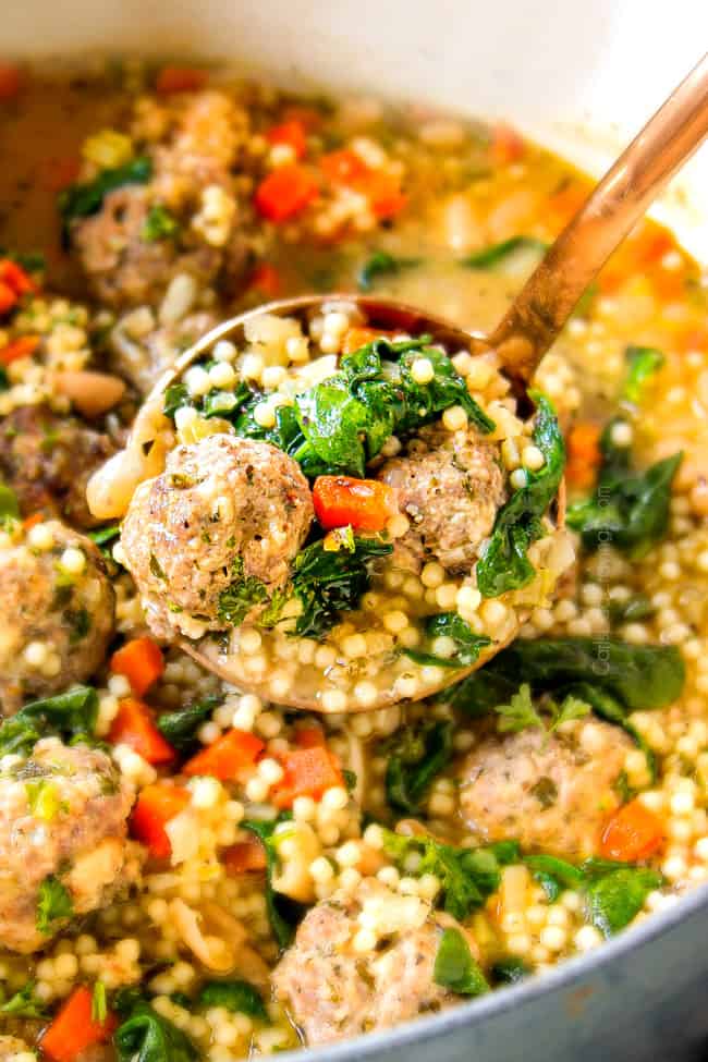 up close of scooping up authentic Italian Meatball Soup recipe with a ladle to serve