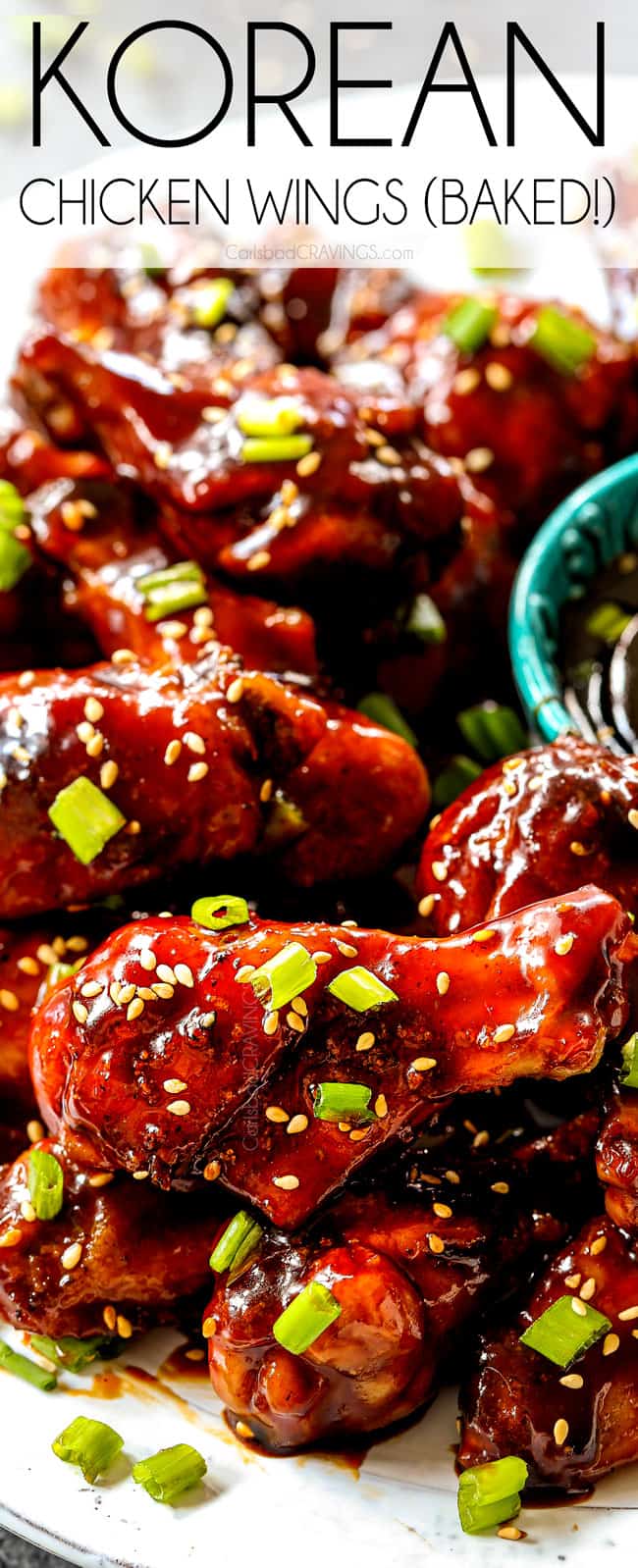 showing how to serve baked Korean Chicken Wings by lining on a platter with gochujang Korean BBQ Sauce