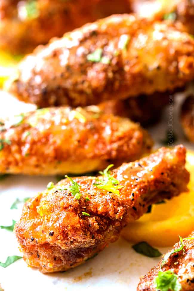 up close of lemon pepper chicken wings baked until crispy and served with lemon pepper wings sauce