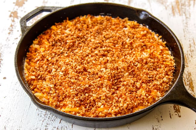 shwoing how to make crab dip by sprinkling top with panko