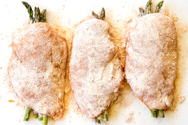 showing how to make chicken piccata recipe by lining dredged chicken up on a cutting board
