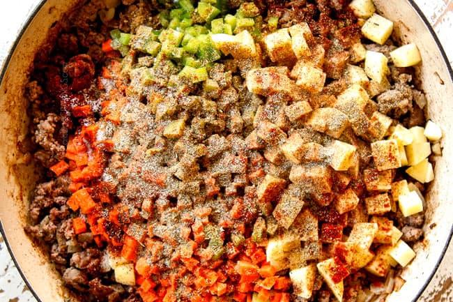 showing how to make Mexican Picadillo recipe by adding potatoes, carrots and bell peppers to ground beef along with all seasonings 