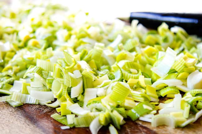 showing how to make potato leek soup by slicing leeks thinly