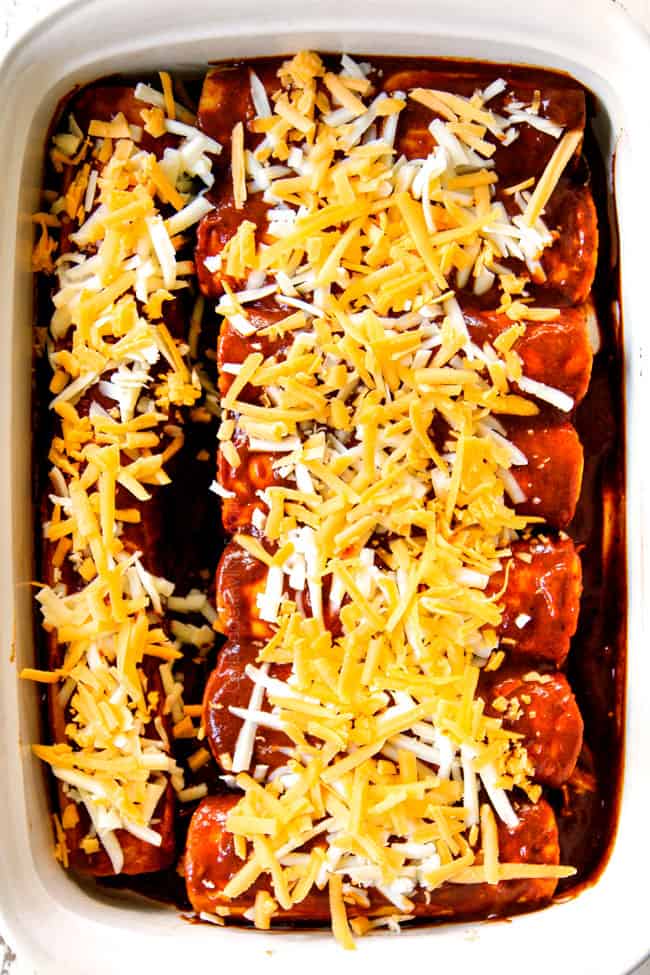 showing how to make chicken  enchilada recipe by adding cheese to the top of enchiladas before baking