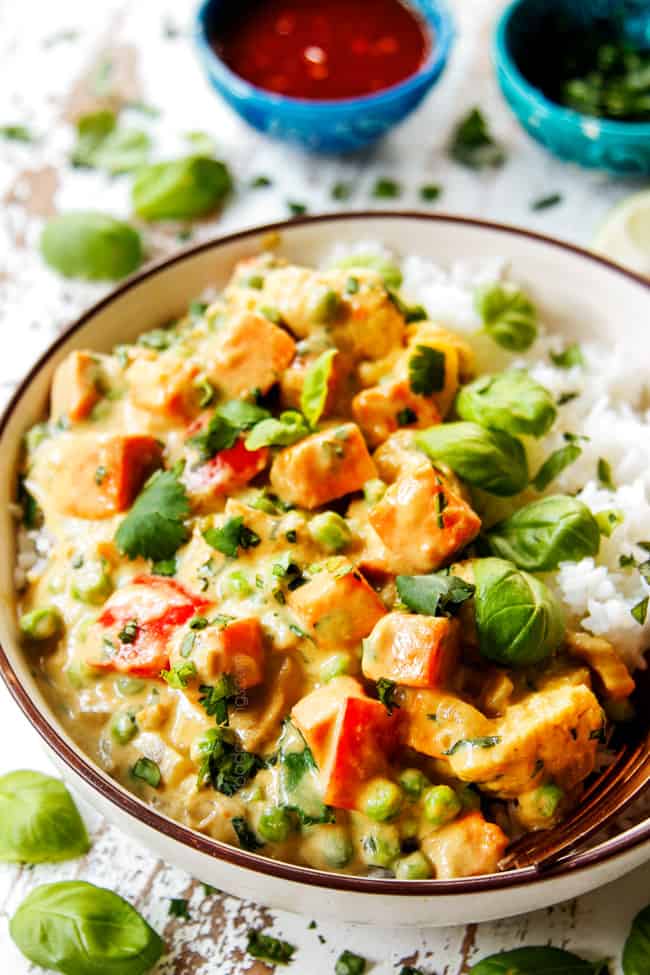 showing how to serve green chicken curry recipe by adding to rice in a bowl