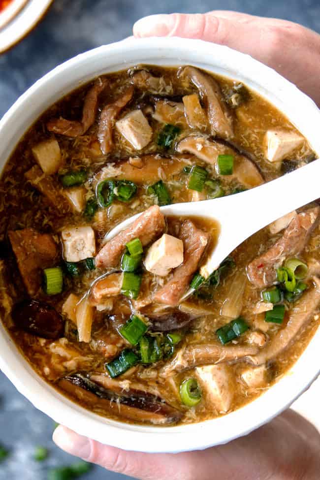 two hands holding a bowl of easy Hot and Sour Soup recipe