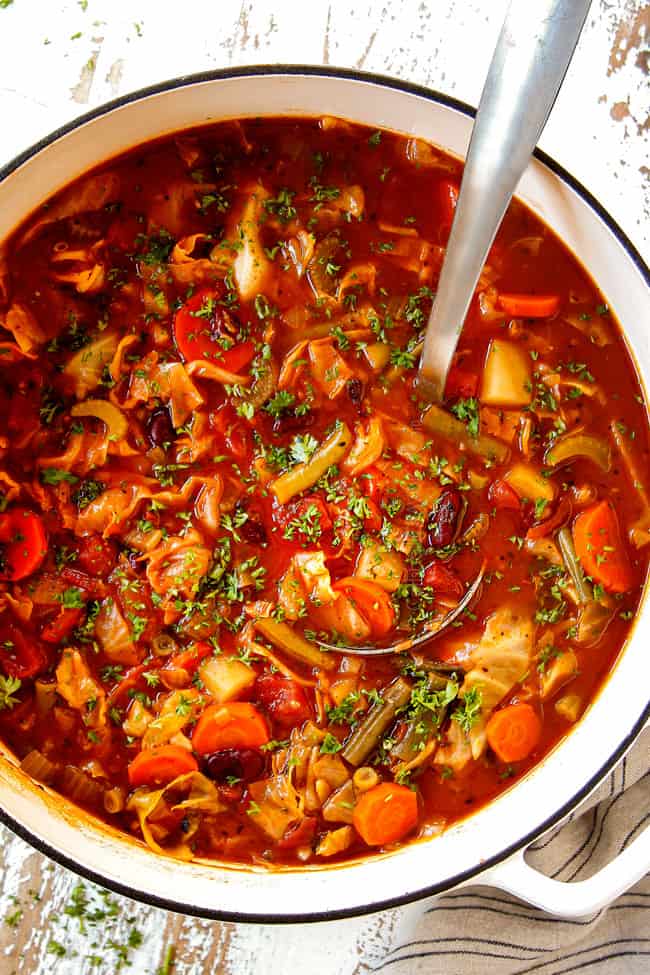top view showing how to make Vegetable soup with Cabbage by stirring in a splash of lemon juice