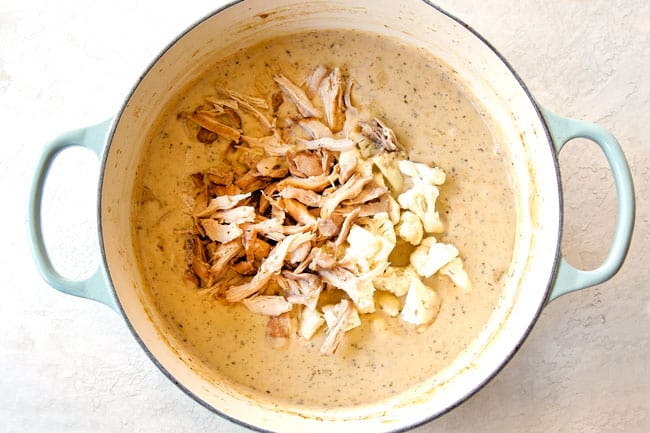 showing how to make chicken and rice soup by adding shredded chicken and cauliflower to pot