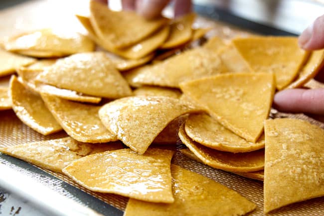 showing how to make Chilaquiles by slicing corn tortillas and tossing with olive oil and salt