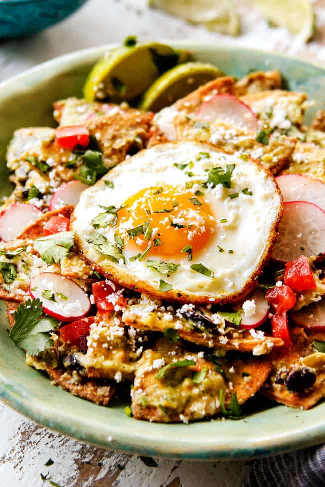 up close of a bowl of Chilaquiles recipe with Fried Eggs showing how to serve chilaquiles