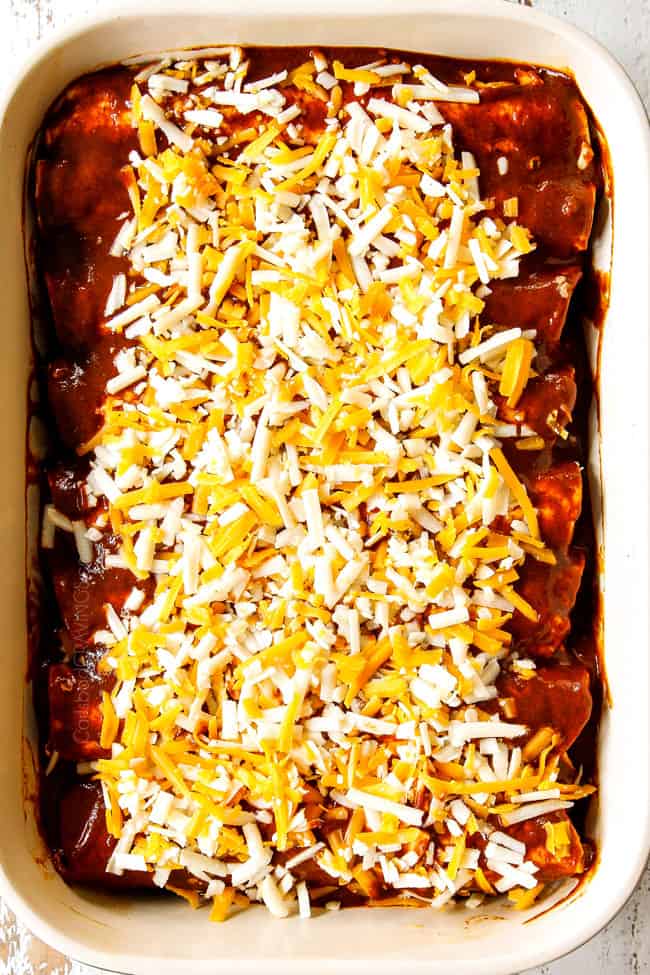showing how to make beef enchiladas by topping rolled tortillas with cheese