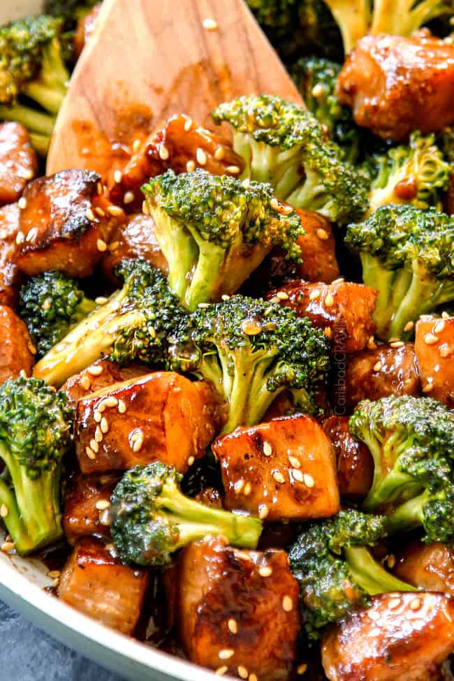 up close of serving chicken and broccoli recipe with a wood spoon