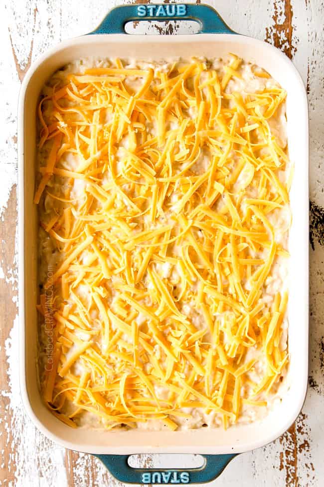 showing how to make hash brown casserole recipe by topping with cheddar cheese