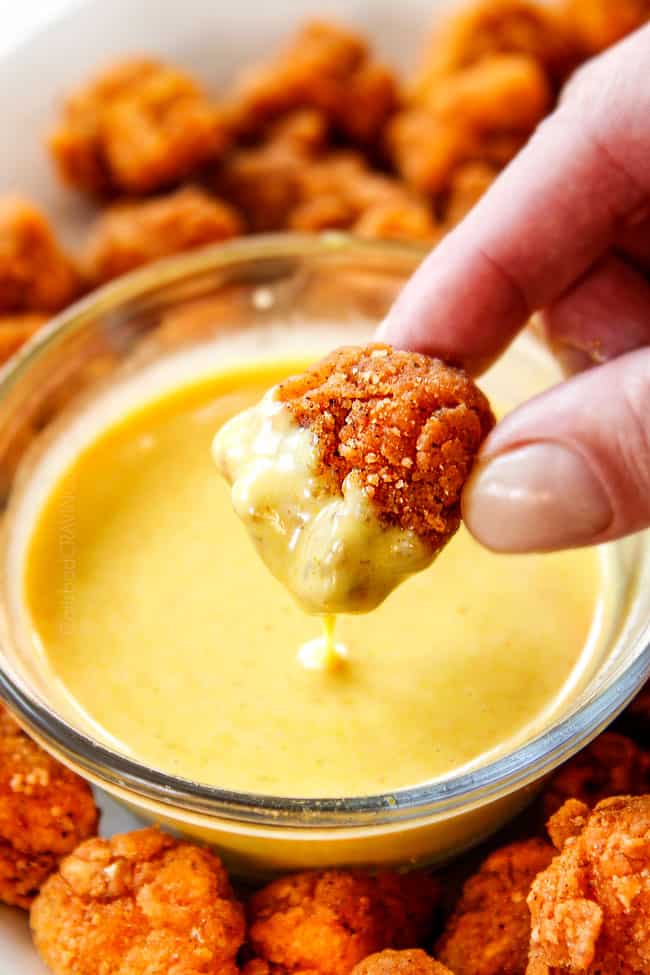 showing how to eat Popcorn Chicken recipe by dipping in Honey Mustard Sauce
