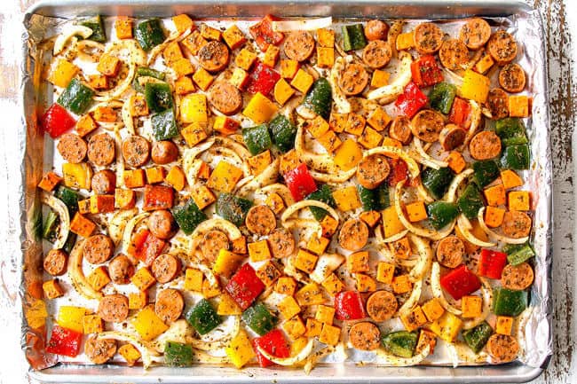 showing how to make baked Italian Sausage and Peppers by spreading sausage, peppers and onions into a single layer