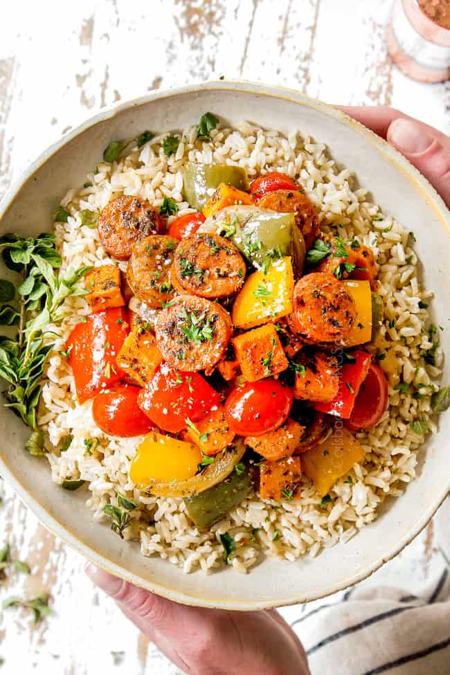 showing how to serve Italian Sausage and Peppers in the oven by adding to a bowl of rice