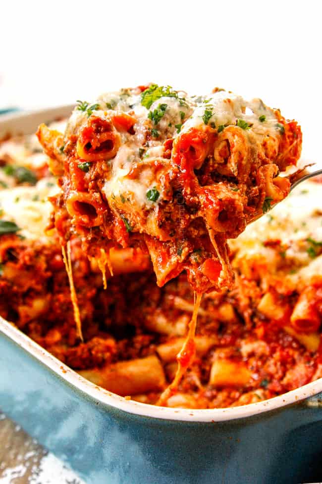 a cheesy pull shot of baked ziti recipe with ricotta, Italian sausage and meat showing how cheesy it is