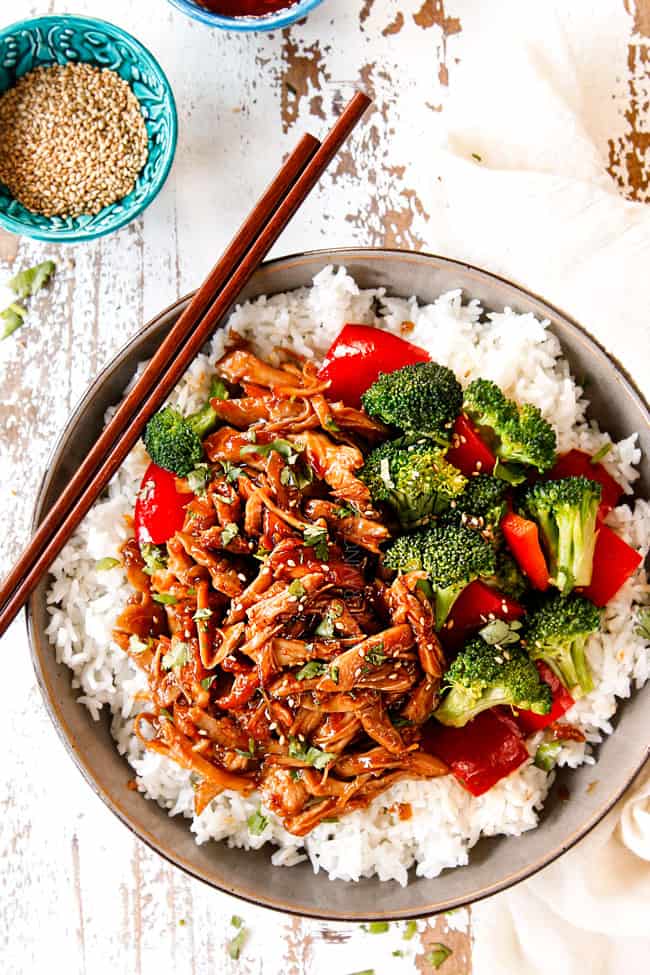 showing how to serve crockpot honey garlic chicken recipe by adding to a bowl with rice and a broccoli, bell pepper stir fry