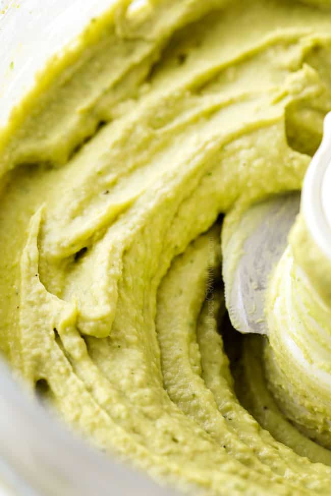 up close of hummus in a food processor showing how creamy it is