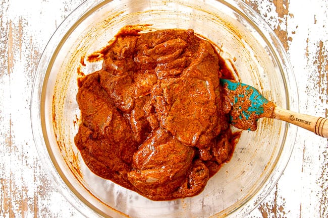 showing how to make doner kebab by marinating chicken in spiced yogurt marinade in a glass bowl