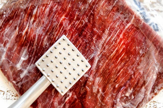 showing how to make flank steak recipe by tenderizing with a meat mallet 
