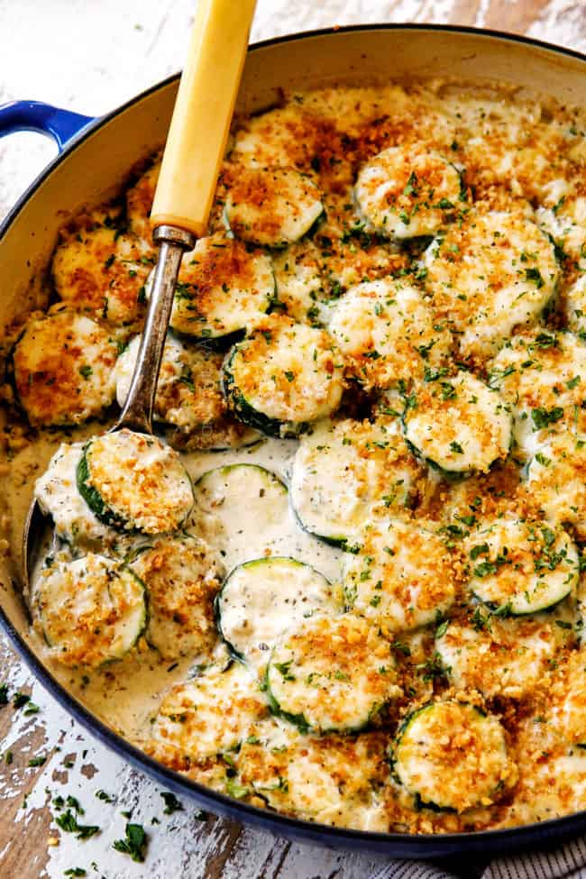 showing how to serve zucchini casserole with a serving spoon
