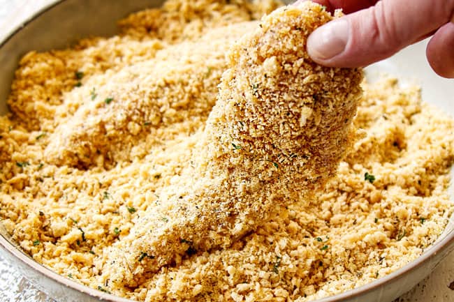 showing how to make Parmesan crusted chicken recipe by breading chicken in panko breadcrumbs