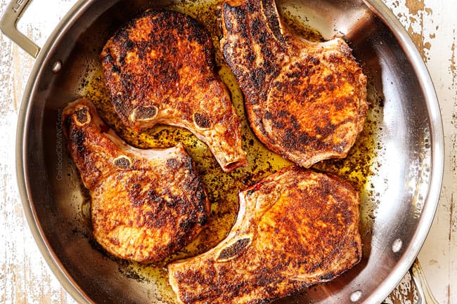 showing how to cook pork chops by transferring chops in a skillet to the oven