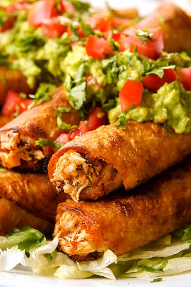 up close of chicken flautas topped with  guacamole