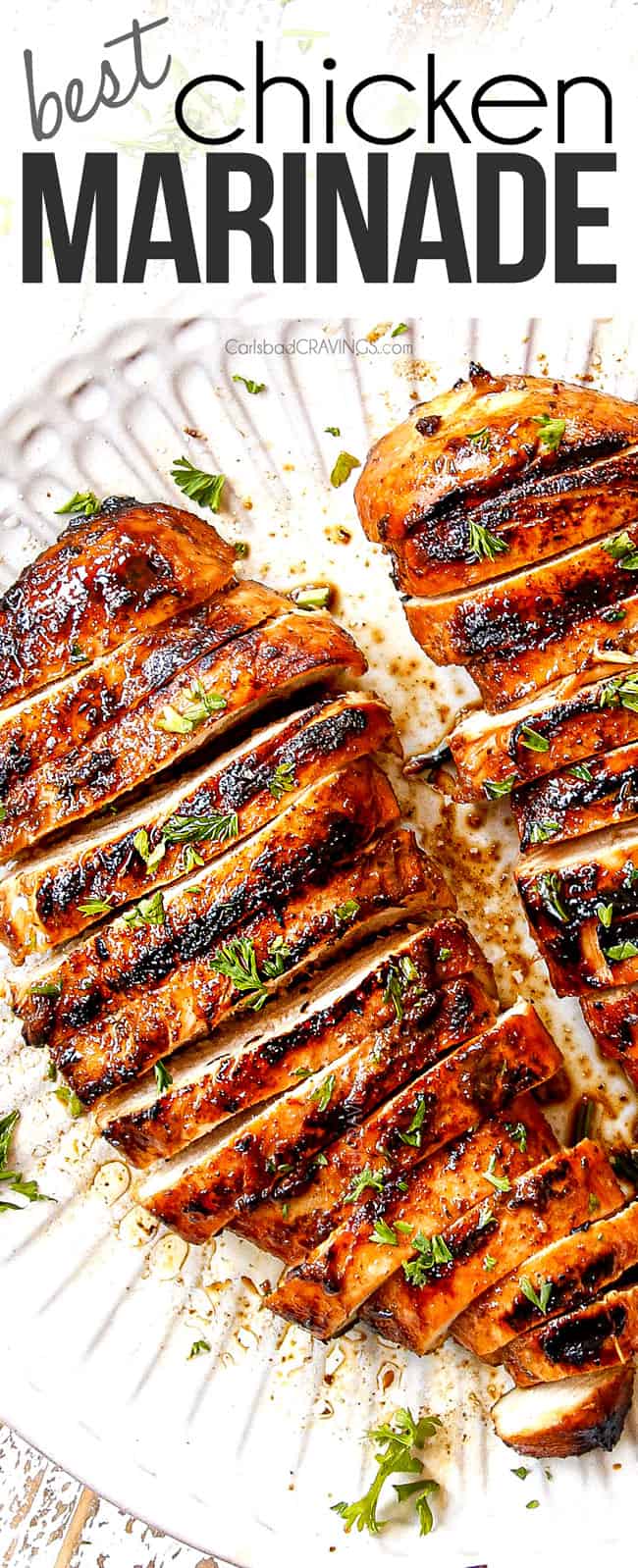 top view of marinated grilled chicken on a white plate 