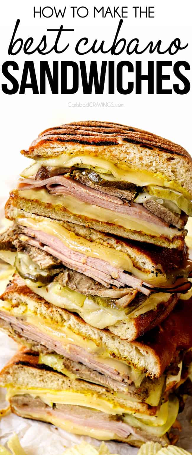 Cuban sandwiches (Cubanos) stacked on top of each other showing the layers of Swiss cheese, ham, mojo pork