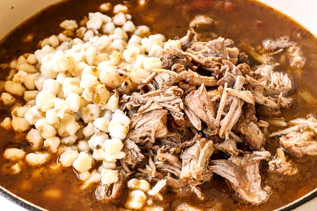 showing how to make  pozole by adding hominy and shredded pork back to stew