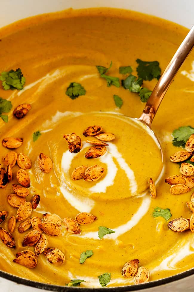 up close of a ladle of pumpkin soup recipe showing how creamy it is