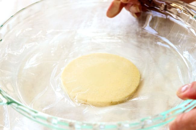 showing how to make Mexican sopes by flattening dough by covering with plastic wrap and pressing down with a pie plate 