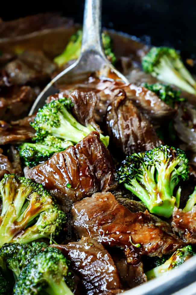 showing how to make slow cooker beef and broccoli by stirring sauce and broccoli together